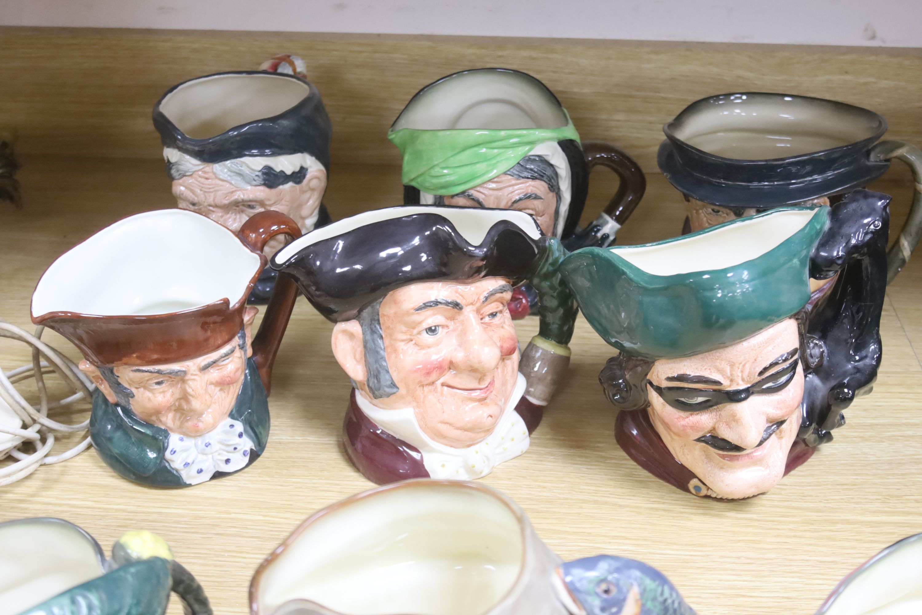 A large collection of nine Royal Doulton character jugs including Falsestaff, The Poacher, Old Charley, Mine Host, Dick Turpin, Granny and three others